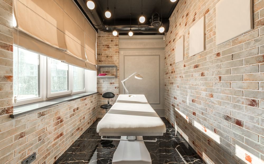 Cosmetology treatment bed in a bright aesthetic clinic Cosmetology treatment bed in a bright aesthetic clinic