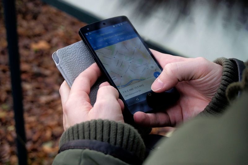 Person using Google Maps to find a nearby business Person using Google Maps to find a nearby business